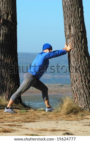 Middle age man making stretching movements before run