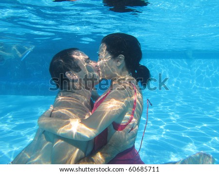 Lovely Couple Underwater On A Swimming Pool, Underwater Photo ...