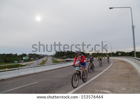 Yala, Thailand - September 8: Bikers ride bicycles on highway in Yala-Pattani 418 Mountain Bike Racing 2013 on Sep 8, 2013 in A.Muang Yala, Thailand