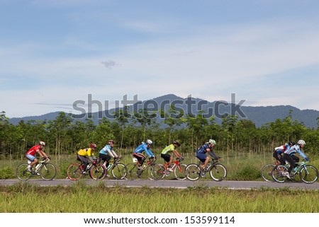 Yala, Thailand - September 8: Bikers ride mountain bicycles on road number 418 in Yala-Pattani 418 Mountain Bike Racing 2013 on Sep 8, 2013 in A.Muang Yala, Thailand