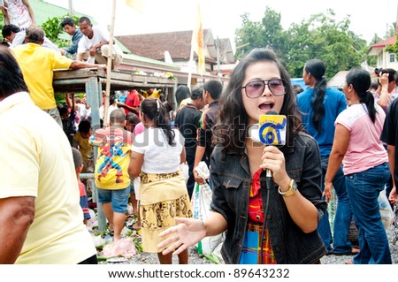 YALA, THAILAND - SEPTEMBER 27:  Unidentified news reporter reports for people catch ghost food in Yala Cave Temple Buddhism Day on Sept 27, 2011 at Cave Temple Yala, Thailand