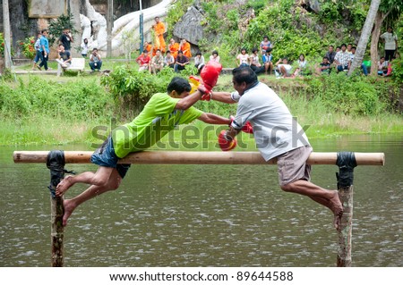 YALA, THAILAND - SEPTEMBER 27:  Unidentified men fight for ocean boxing in Yala Cave Temple Buddhism Day on Sept 27, 2011 at Cave Temple Yala, Thailand