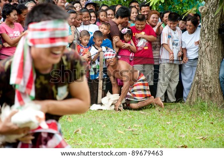YALA, THAILAND - SEPTEMBER 27:  Unidentified man catches duck for ducks catch contest in Yala Cave Temple Buddhism Day on Sept 27, 2011 at Cave Temple Yala, Thailand