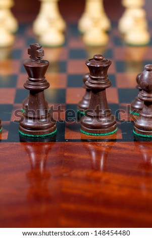 Closeup black king and queen Set of chess figures on the playing board
