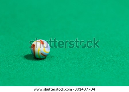 Blue and yellow Colorful Marble Ball on Green background