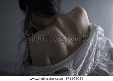 Beautiful back of asian female lying on bed