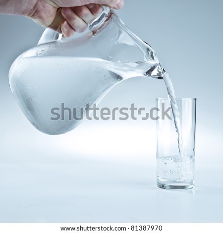 Water pitcher pouring a glass of fresh water