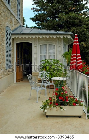 French guest house terrace with chairs and table