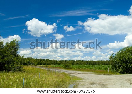 Colorful cloudscape, road, grass and fields