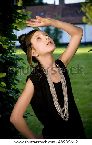 Teenage fashion girl showing off clothes and jewelry in park