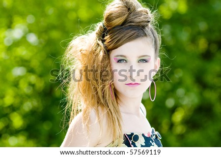 Closeup teenage girl model presenting clothes in the park natural background