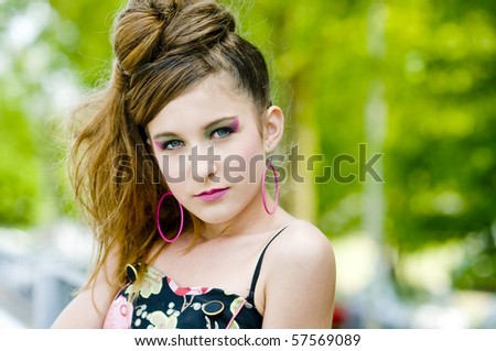 Closeup teenage girl model presenting clothes in the park near the water and a bridge