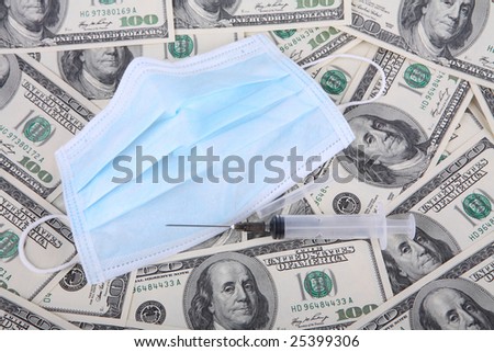 syringe on a background of 100 dollar bills