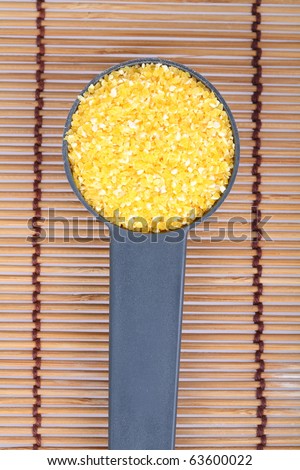 corn grits poured into a spoon