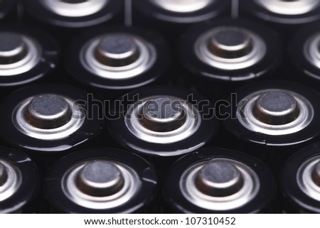 close up the top of AA battery,color on black