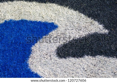 Logo in the center of an american football field with artificial turf