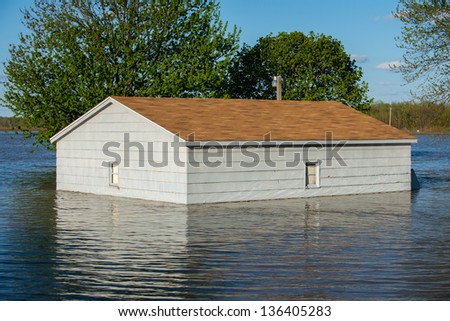 Small building is surrounded by flood waters from the Wabash River in the small town of York, Illinois