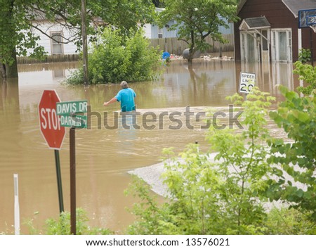 A man wades through flood water in rural Indiana