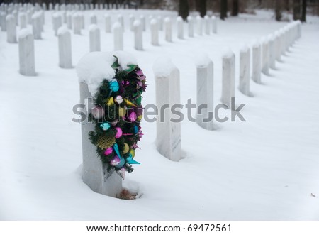 Christmas wreath hanging on a grave stone in Jefferson Barracks National Cemetery near St. Louis, Missouri.