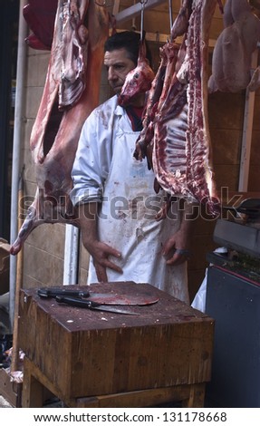 PALERMO - DECEMBER 29: butcher sells meat on the local market in Palermo, called Ballaro. This market is also tourist attraction in Palermo, Sicily, Italy on Dec. 29, 2012.