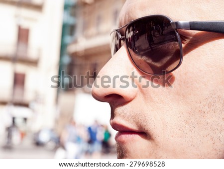Close up handsome man. Profile - portrait of a attractive gorgeous guy wearing sunglasses, outdoor-park