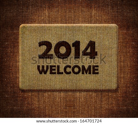 Happy new year 2014, welcome doormat carpet isolated on white. the same concept available for 2015 and 2016 year. (clipping path included)
