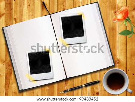 Biography or curriculum vitae Conceptual image, blank opened book outdoors on wooden disk Pen, blank photo frame and cup of tea.