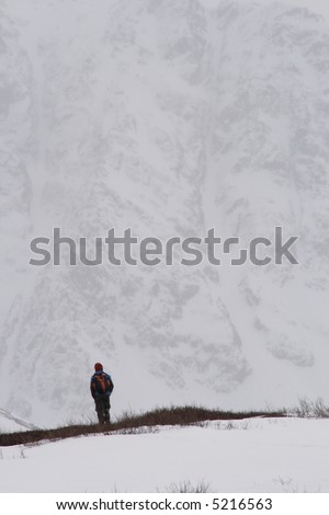 A women walking in front of a large mountain