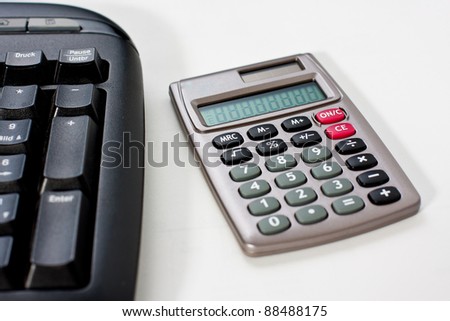 Close-up of a calculator with a computer keyboard