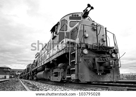 Diesel electric freight train engine locomotive marshaled in tandem and riding on a rail track in a railway depot railroad yard