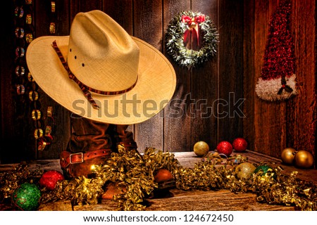 American West rodeo traditional white straw cowboy hat atop rancher boots with festive Christmas display decoration in authentic country wood barn for a nostalgic Western Christmastime greeting card