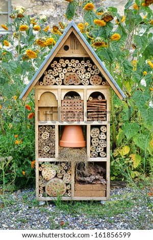Craftsman built insect hotel decorative wood house with compartments and natural components refuge made to protect and promote ladybugs and butterflies hibernation as useful garden pests