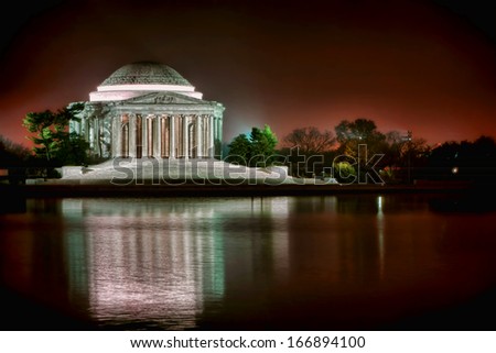 Thomas Jefferson Memorial famous American landmark with light reflections on the water of the Tidal Basin in West Potomac Park at night in the capital of the United States of Washington DC