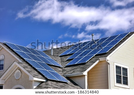 Clean green energy efficient saving source photovoltaic solar panels cells modules on residential house roof over cloudy sky producing free renewable electricity
