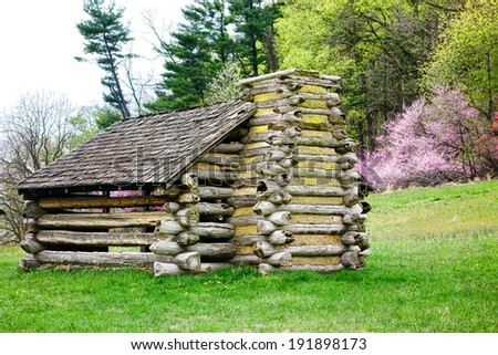 American Revolutionary War soldiers housing log wood cabins at Valley Forge National Historical Park military encampment of the Continental Army in the spring near Philadelphia in Pennsylvania