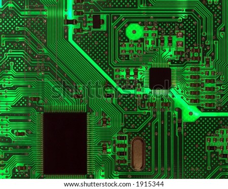 Detail of a computer circuit board with chips back lit from behind as an electronic background