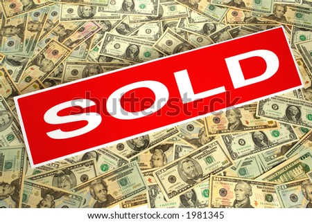 Real estate red sold rider sign over dollar bills background