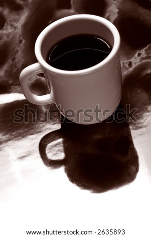 Cup of black coffee on cafe polished marble counter in vintage nostalgic sepia
