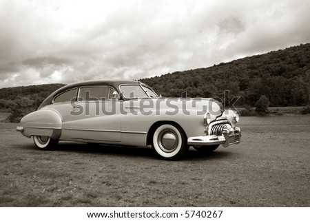 stock photo Vintage old car speeding on a country road with very slight