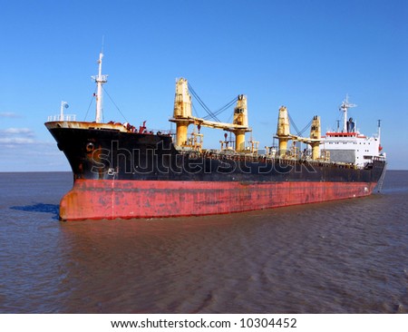 Empty bulk carrier cargo ship sailing on calm waters