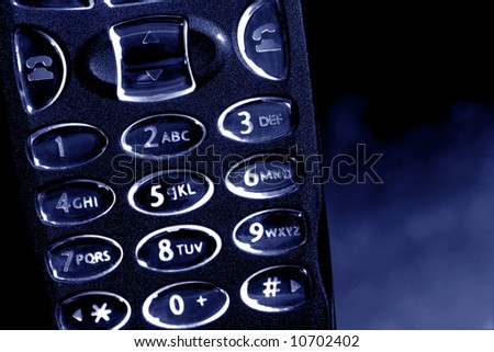 Blue tone backlit cell phone key pad with glowing number keys