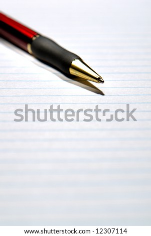 Ballpoint pen on a blank sheet of ruled paper
