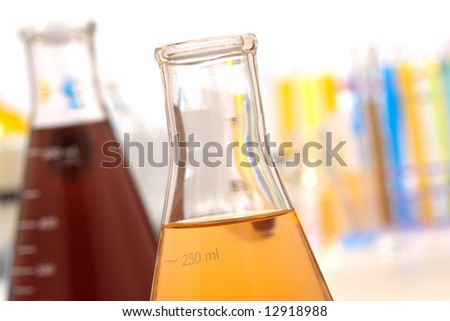 Glass Erlenmeyer flask in research lab background
