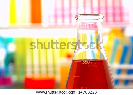 Scientific laboratory glass conical Erlenmeyer flask filled with red chemical liquid for a chemistry experiment in a science research lab
