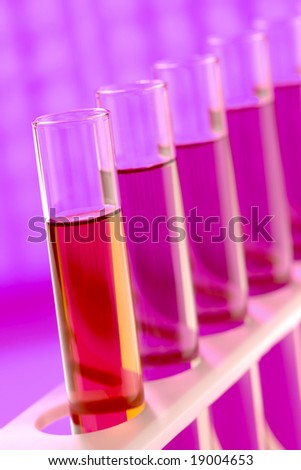 Laboratory glass test tubes filled with red liquid on a rack for an experiment in a science research lab