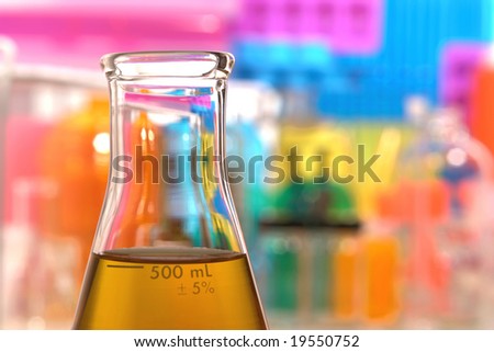 Scientific laboratory glass conical Erlenmeyer flask filled with amber chemical liquid for a chemistry experiment in a science research lab