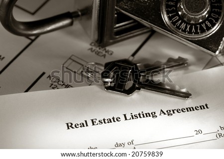 Real estate listing contract with house keys and combination lock box