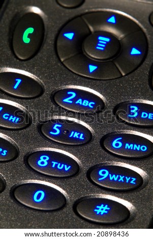 Open flip cell phone with backlit key pad with glowing blue number keys