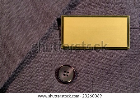 Blank gold and brass name tag on corporate business man suit jacket breast pocket with empty copy space for text insertion