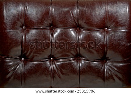 Padded furniture shiny brown leather like vinyl background